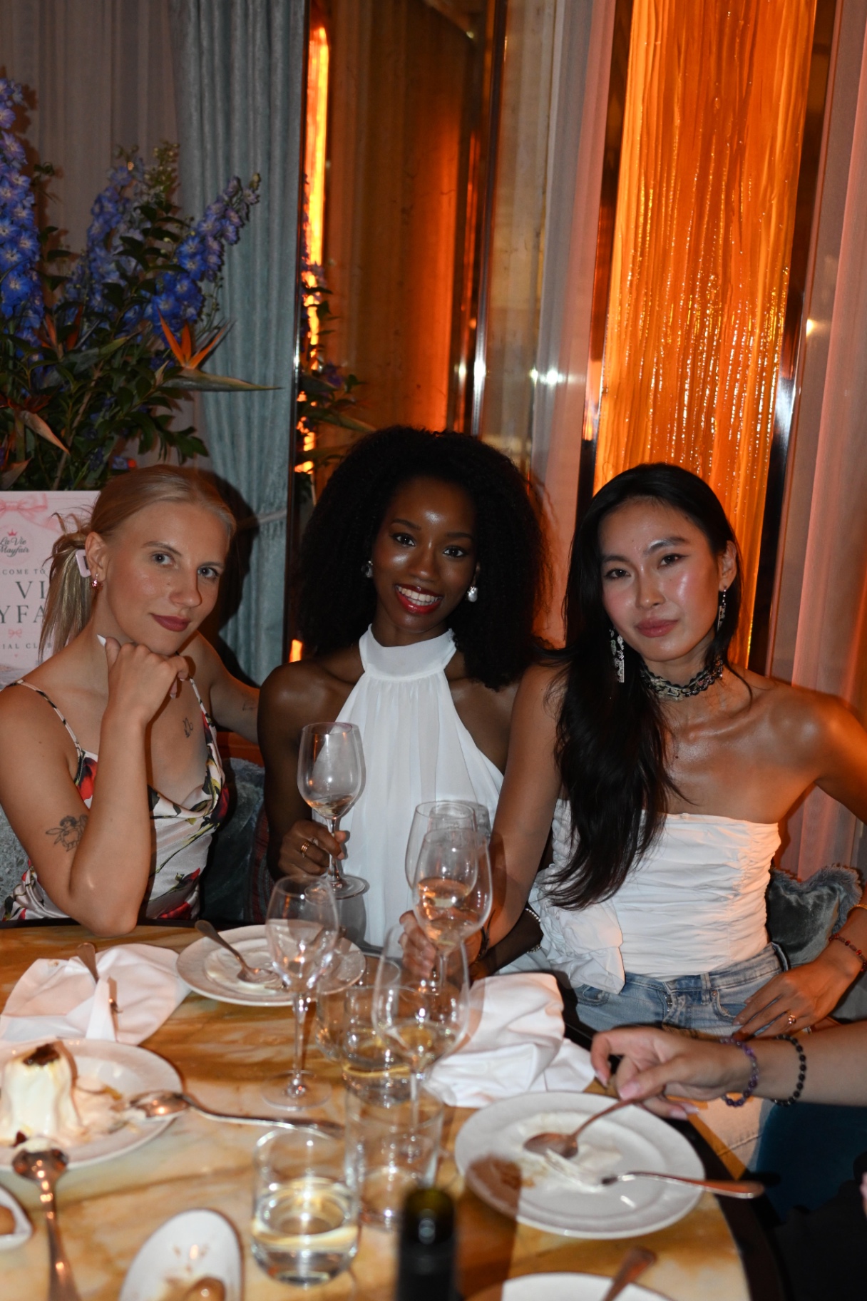 Three members toasting with wine at the members' dinner