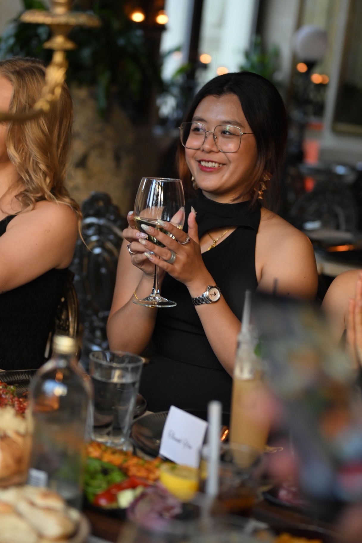 A member raising her glass of wine at the dinner