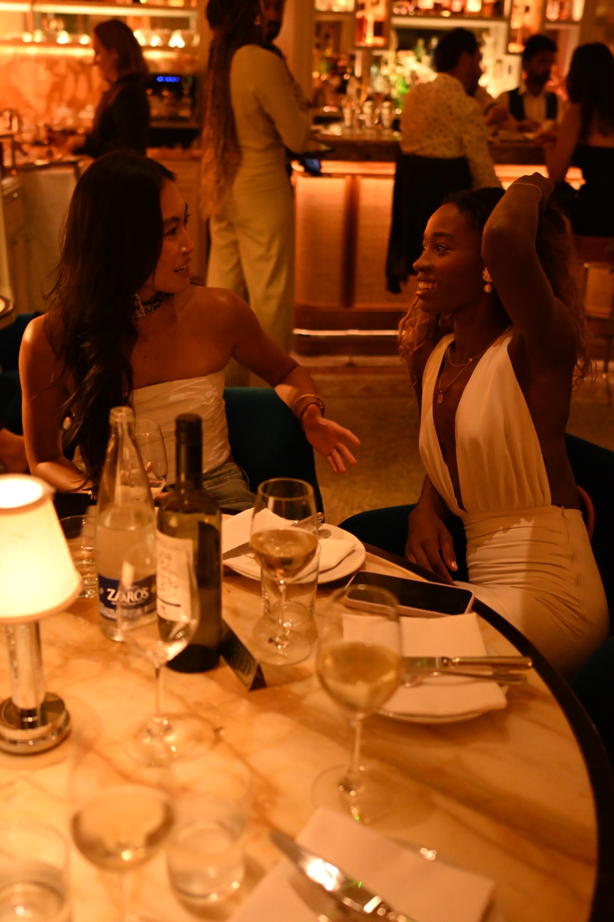 Two members chatting over dinner at the marble table