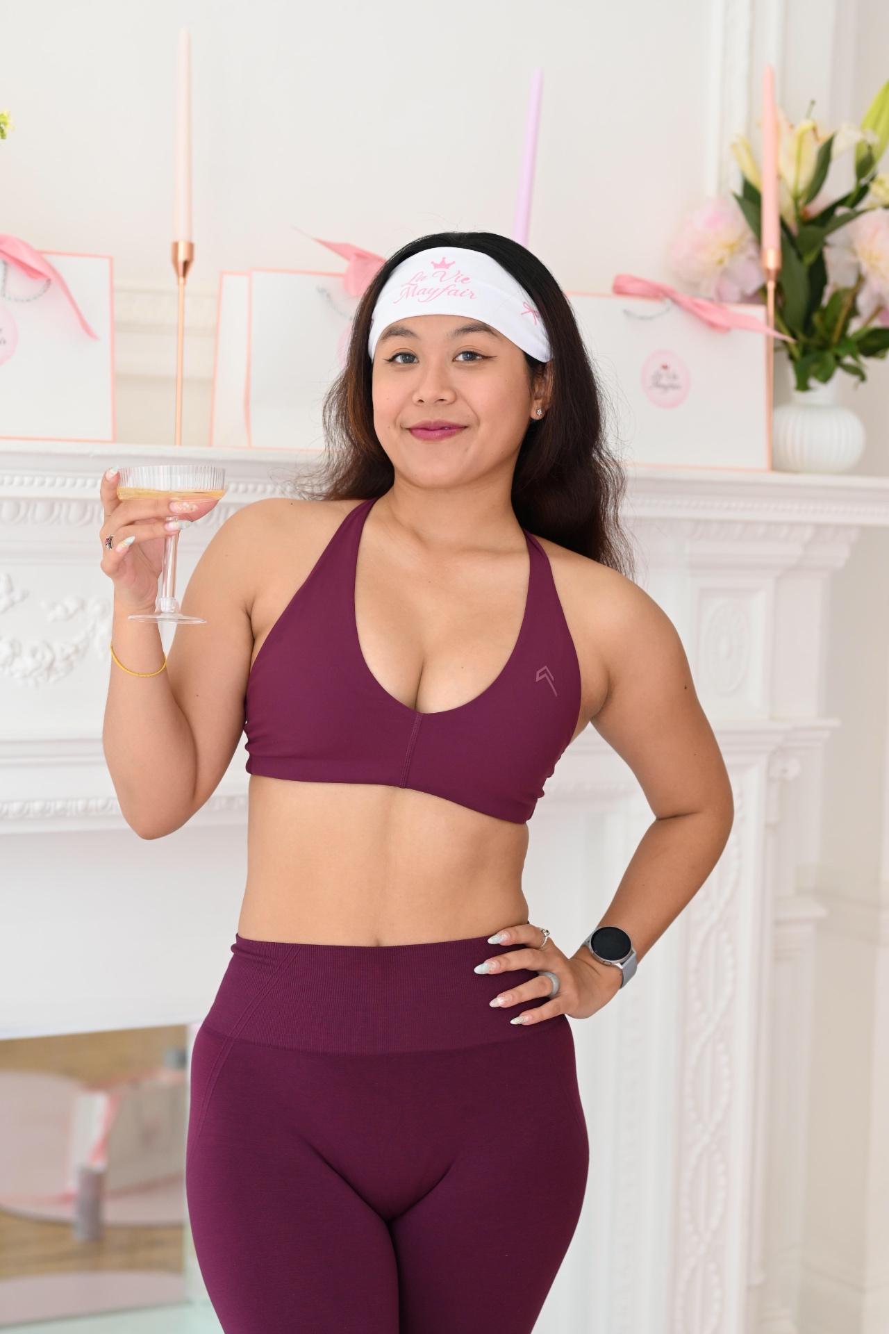 A member toasting by the fireplace in a La Vie Mayfair headband