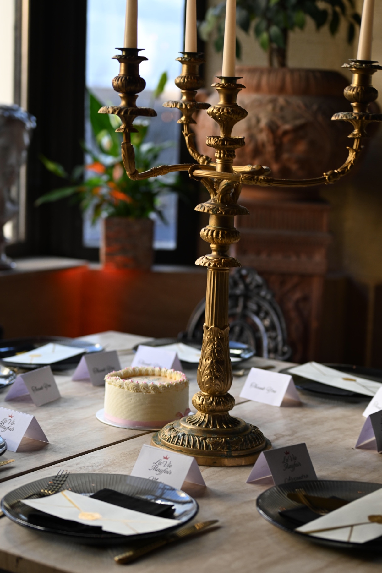 Gold candelabra and cake on the marble dinner table
