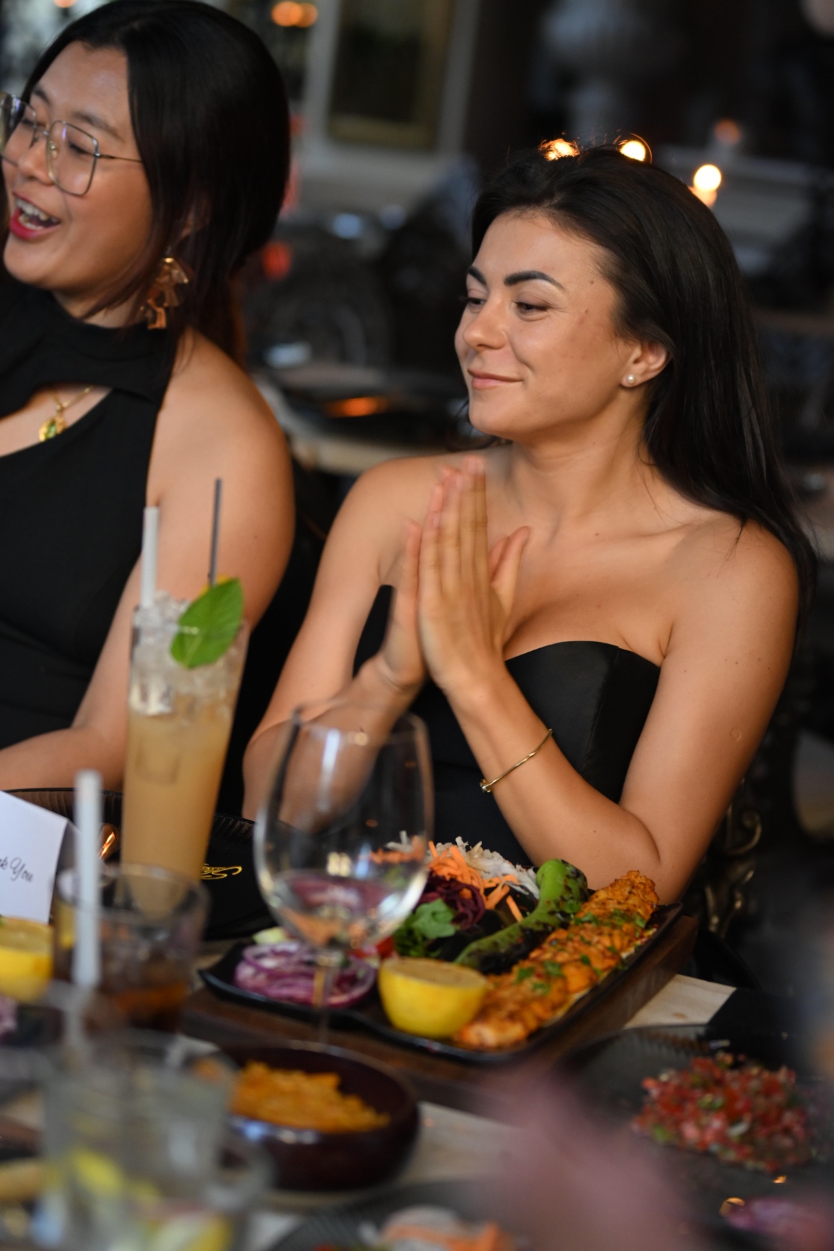Members applauding over sharing plates at Sheesh Mayfair