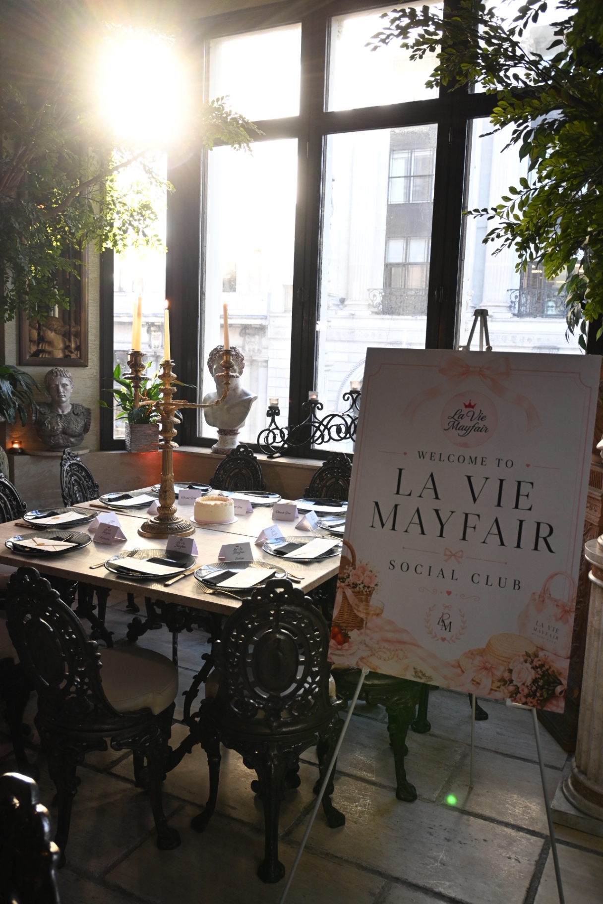 Sunlight over the set table and welcome sign at Sheesh Mayfair