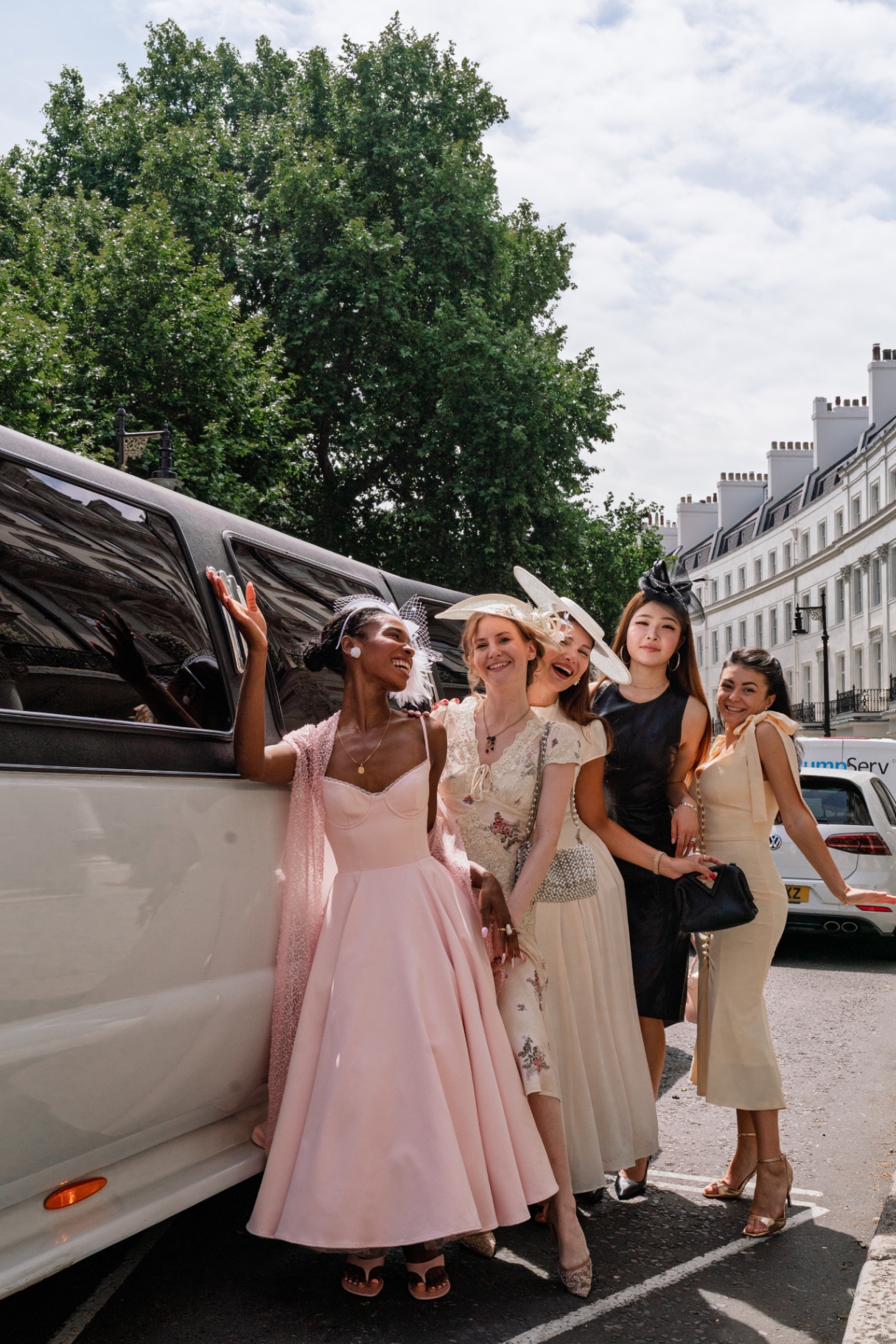 Members laughing beside the limousine before Royal Ascot