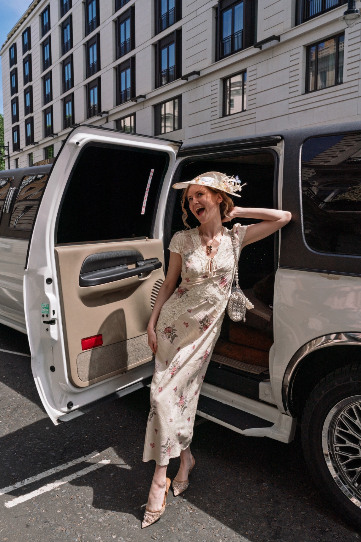 A member stepping out of the limousine in a floral silk dress