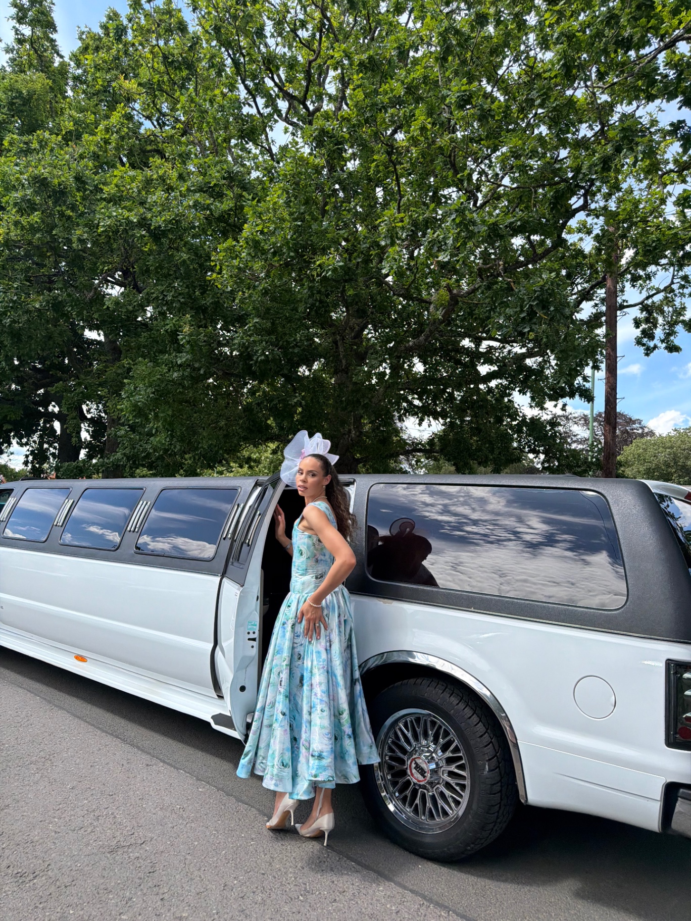 A member arriving at the racecourse beside the white limousine