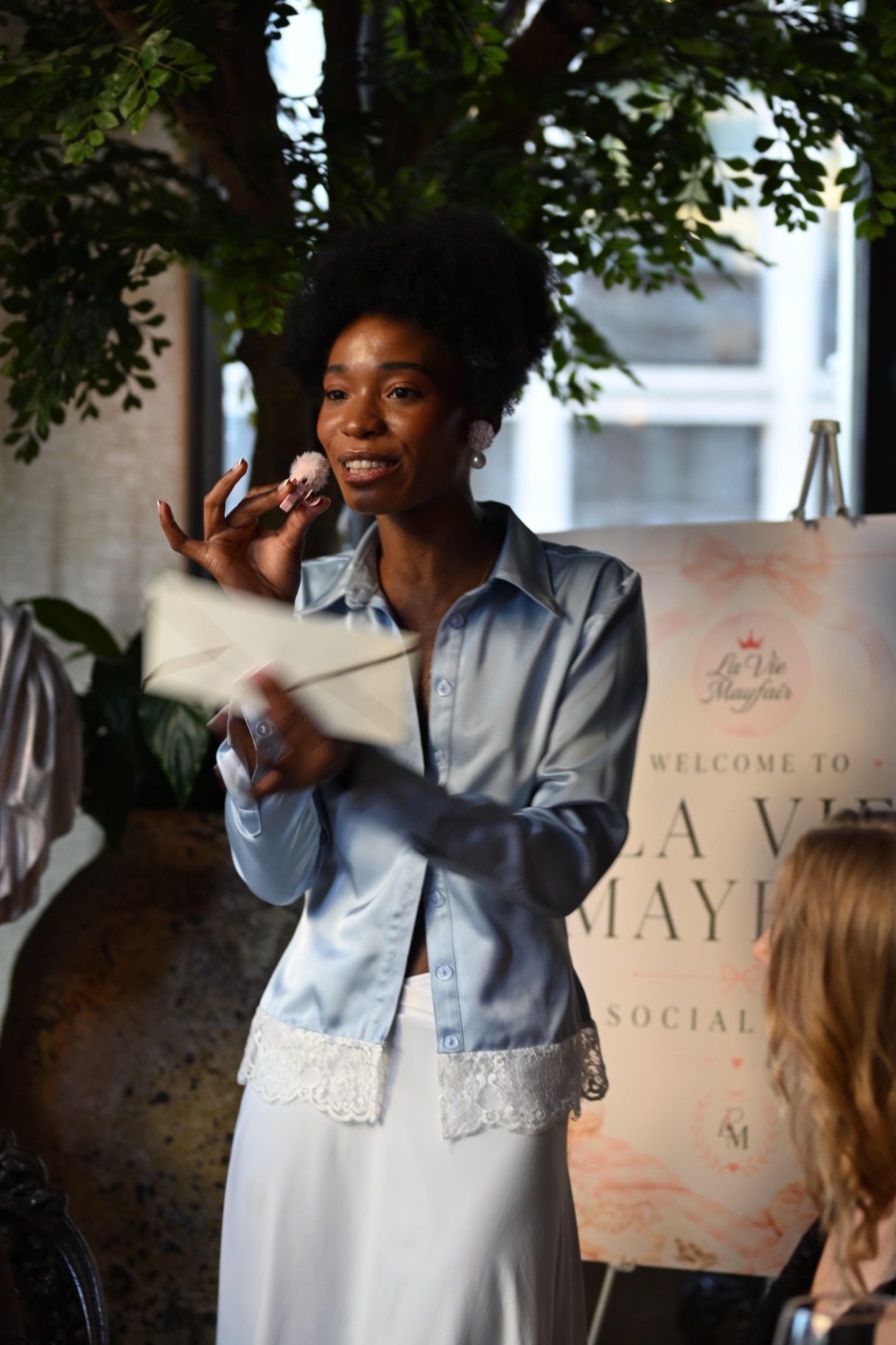 A member opening the evening with her invitation in hand