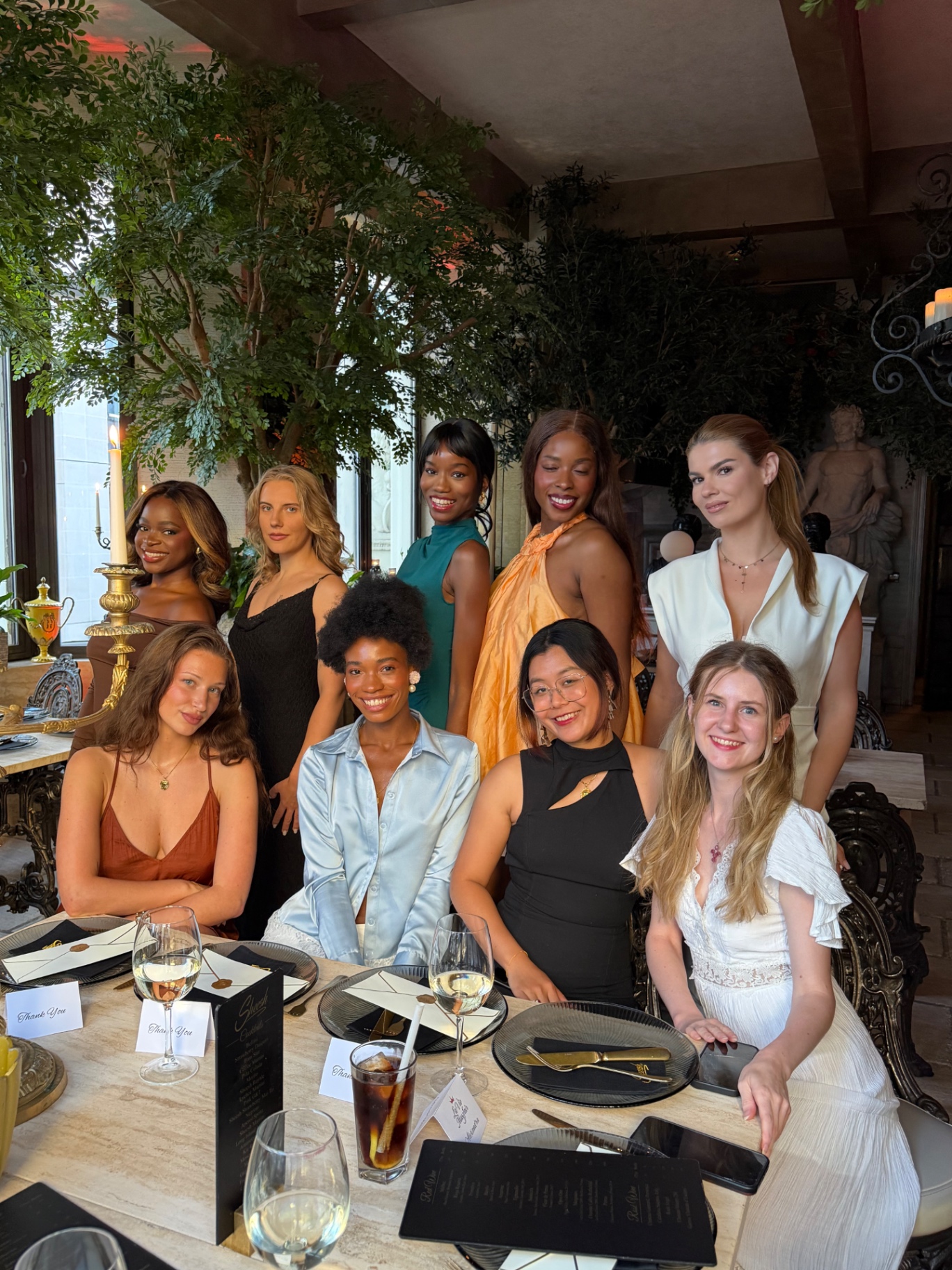 Group portrait of members around the table at Sheesh Mayfair