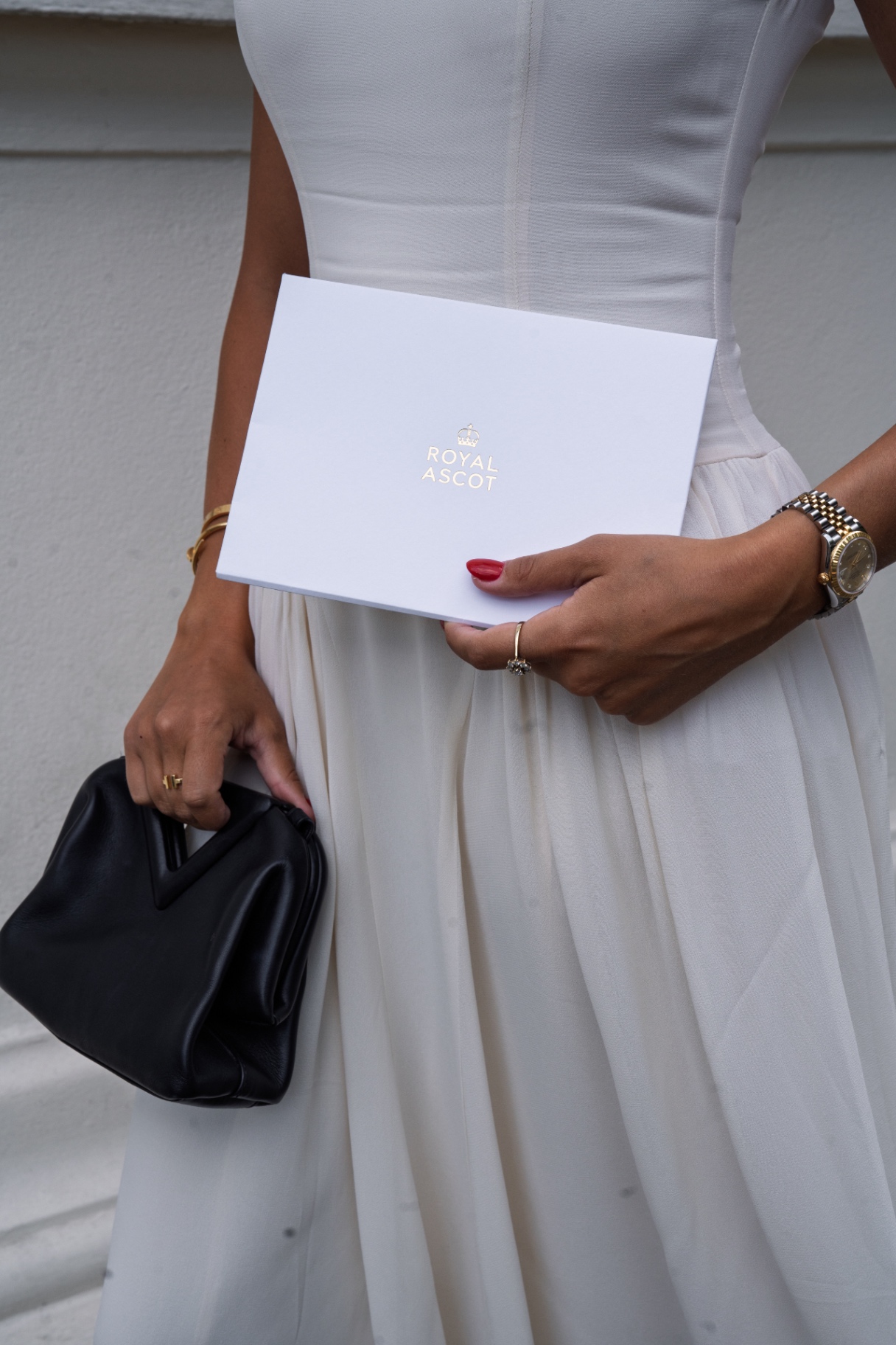 A member holding her Royal Ascot ticket box